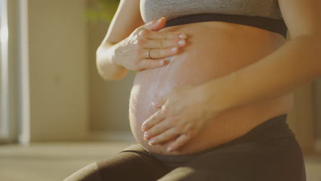 pregnant woman massaging her belly