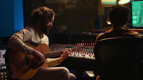 skilled songwriter guitarist playing musical instrument in professional studio