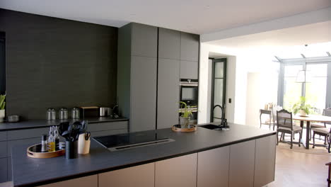 modern kitchen with sleek cabinets and island, utensils neatly organized, copy space