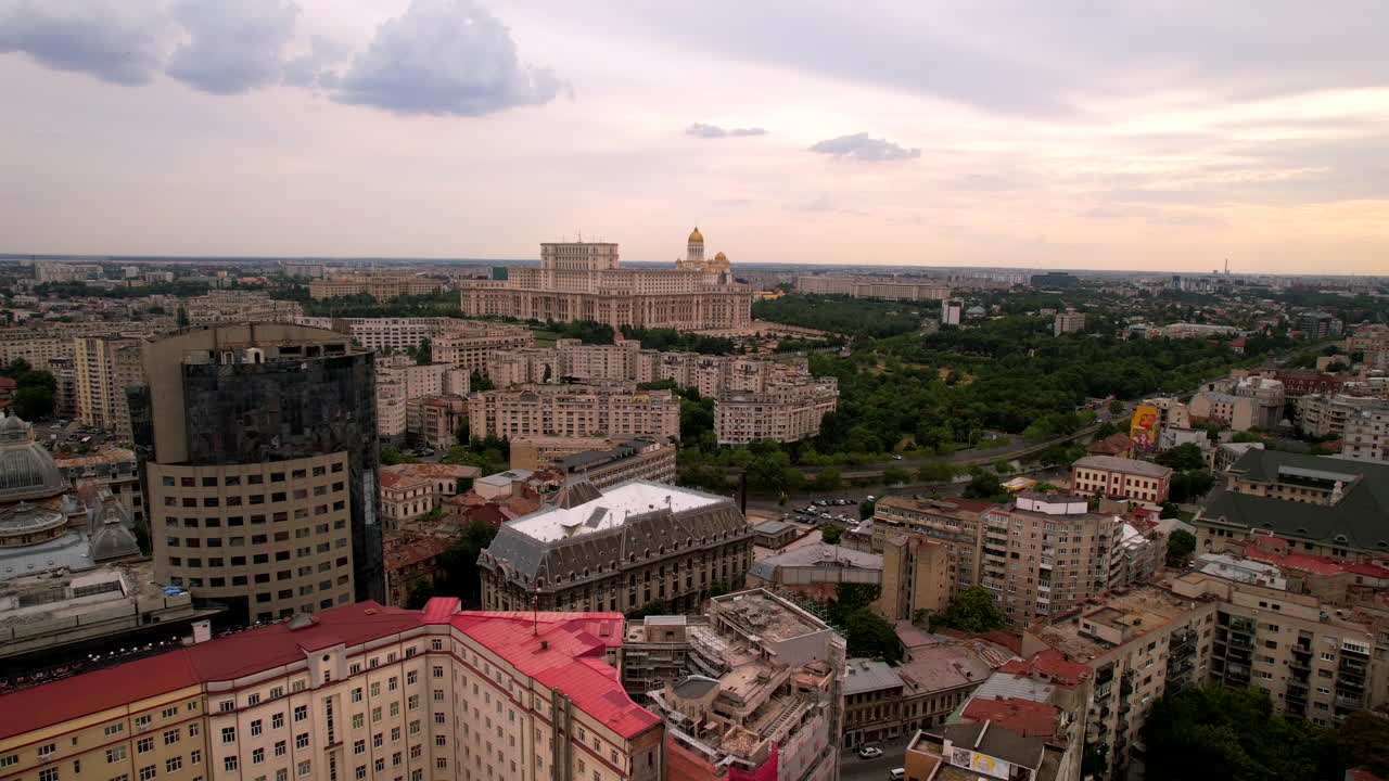 The Romanian Parliament in Bucharest at sunset. Aerial dolly in