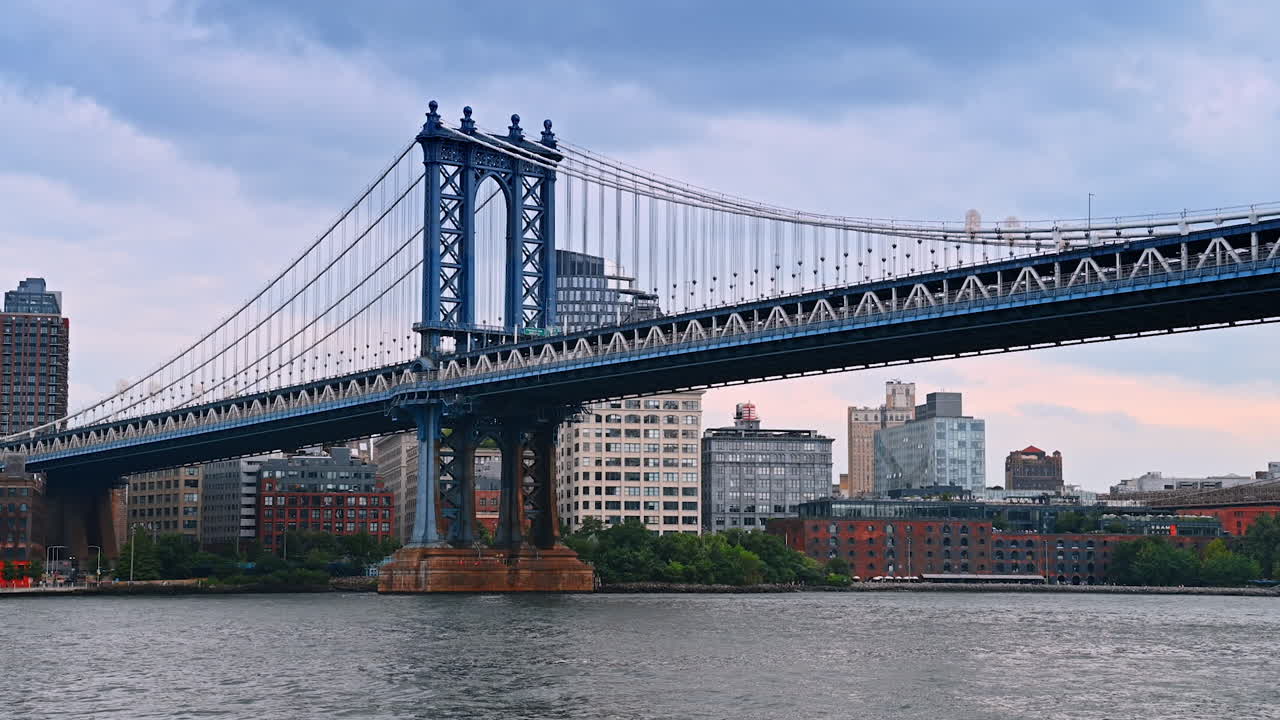 Stunning view on the beautiful Manhattan Bridge from low angle perspective. Skyline of New York at the riverside