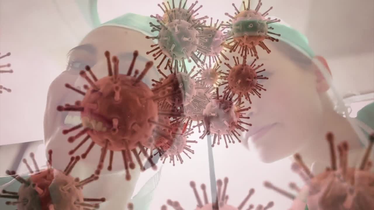 Animazione di cellule del COVID-19 su diversi chirurghi che indossano mascherine in sala operatoria