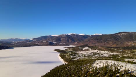 flying over ice covered lake in beautiful landscape