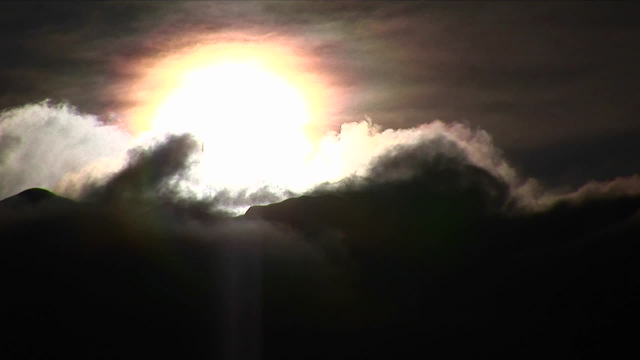 산과 태양 위로 움직이는 구름