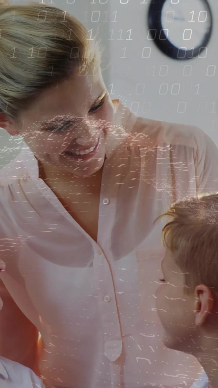 Video verticale: La telecamera si solleva, rivelando una donna che conforta un bambino mentre sorride, con una sovrapposizione tecnologica in aumento.