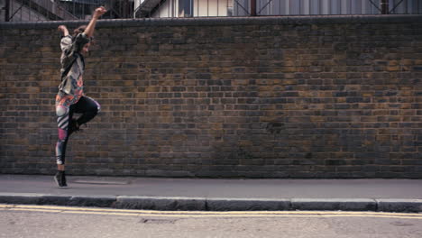 contemporary funky mixed race woman street dancer dancing freestyle in the city