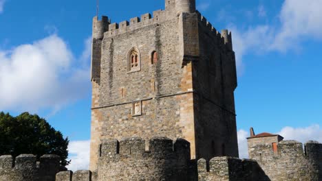 Quick-zoom-in-to-facade-brick-walled-window-of-medieval-castle-in-historic-center-of-Braganza-Portugal