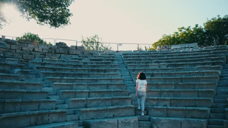 a young woman in the ancient city of teos, located in the touristic town of izmir, seferihisar. turkey