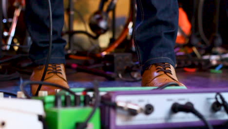 guitar player dancing at a concert in slo-mo