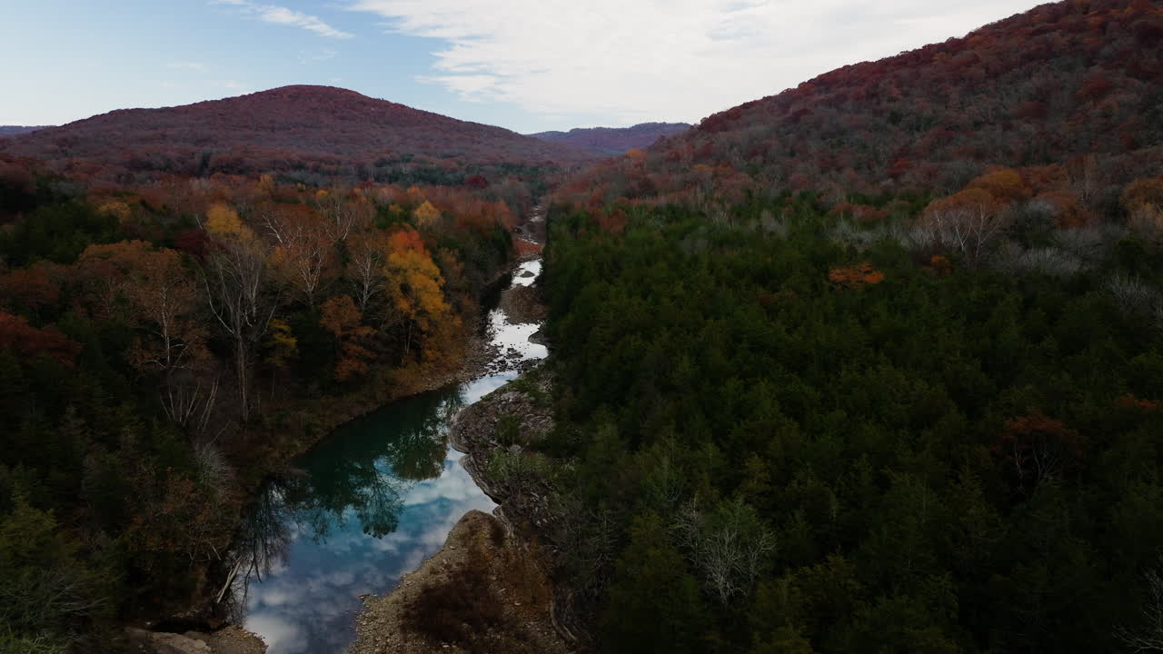 cielos que se reflejan en las aguas de cedar flats piscina natural en arkansas, ee.uu. durante el otoño