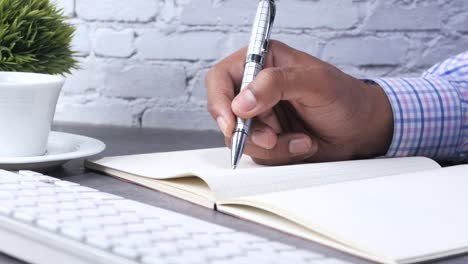 person writing in a notebook