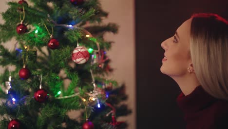 happy woman decorating christmas tree