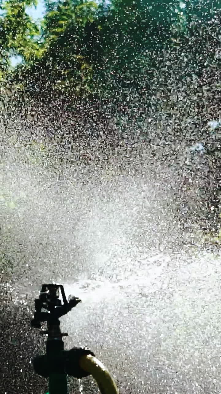Watering garden equipment. Close up view of technique of watering in the garden. Vertical video