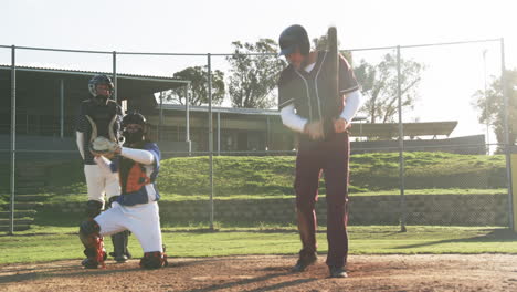 playing baseball, batter holding bat while catcher and umpire ready on field