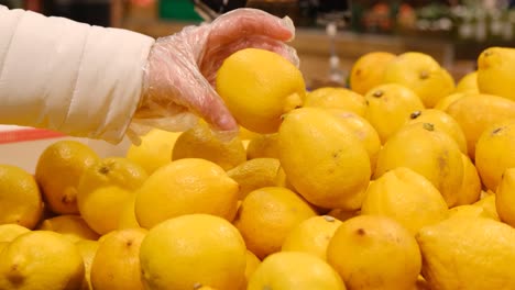 woman at the fruit market buys lemon, citrus, healthy food. vitamin c, natural vitamins