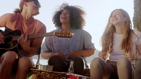 friends singing and playing guitar by