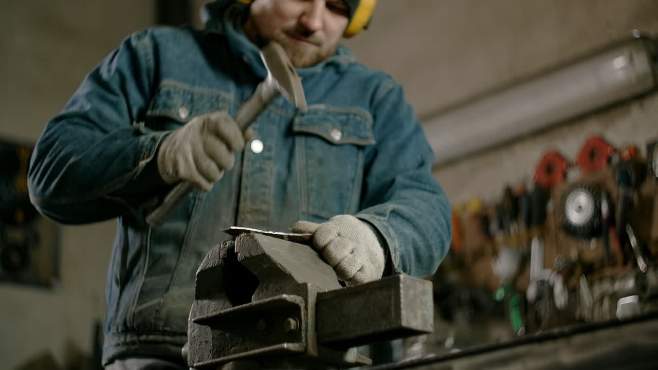 Metalworker Forging Metal in a Workshop