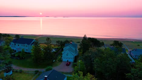 Birds-Flying-Over-Beautiful-Beach-Houses-with-Sunset-on-Vacation-Homes