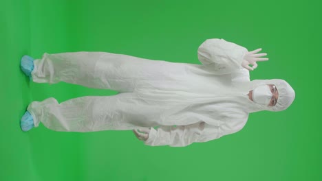 person in protective suit giving ok sign