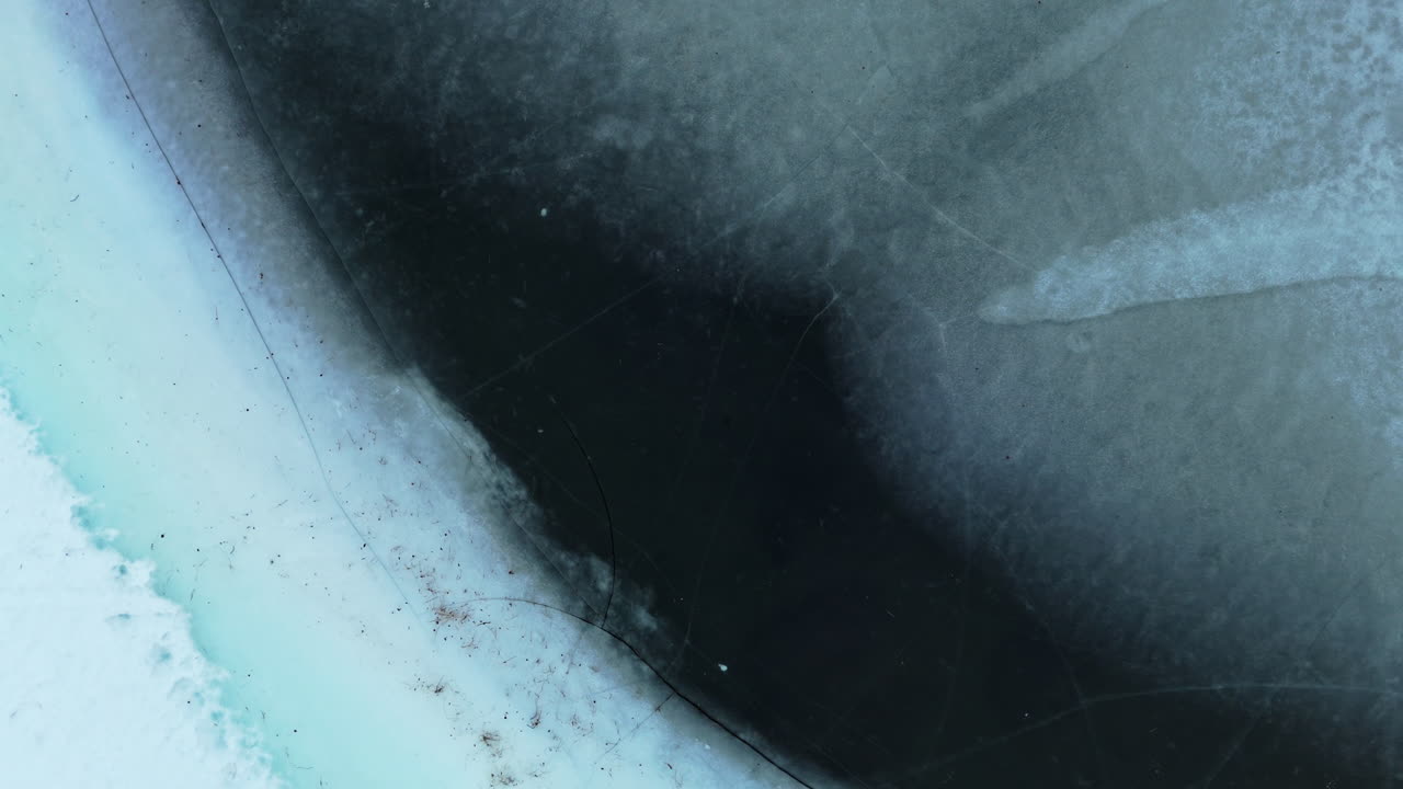 Frozen lake surface with deep cracks and textures, shot in Otertinden, Norway