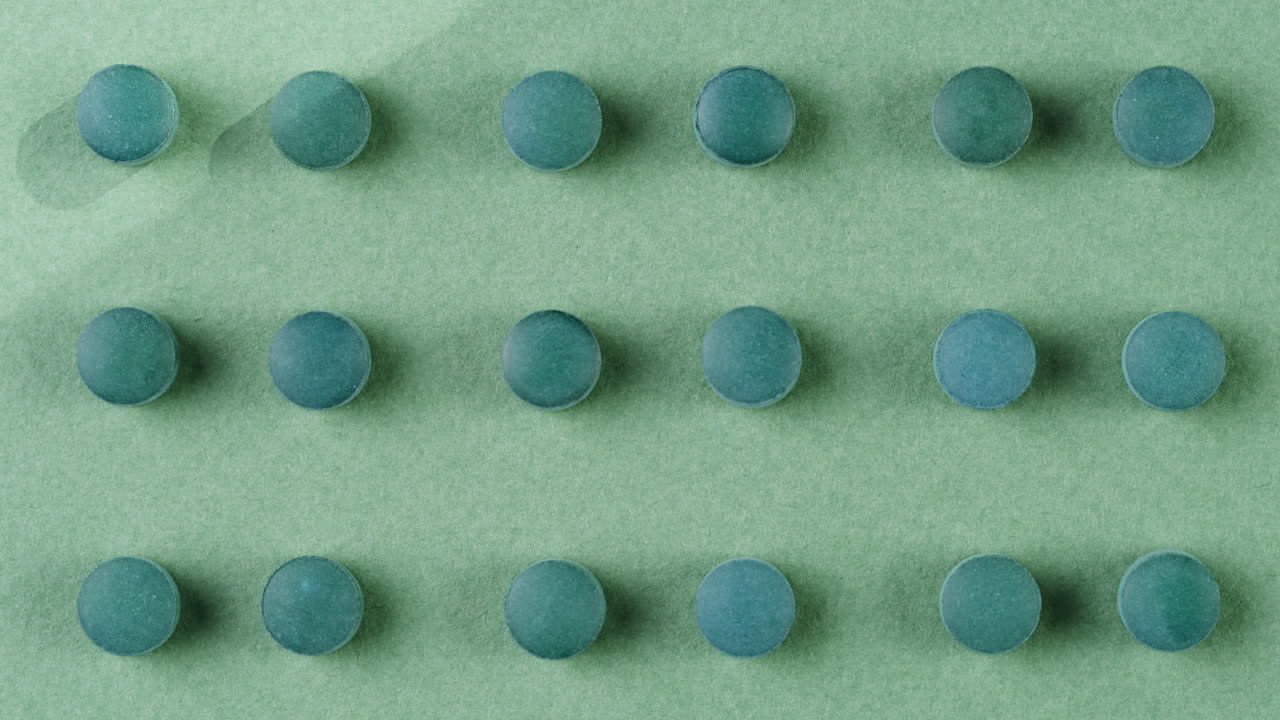 Green mint mentol lollipops, candies, bonbons disappear on purple background. Summer bright texture studio shot for store, supermarket, close up top view. Children favorite sweets made of sugar.