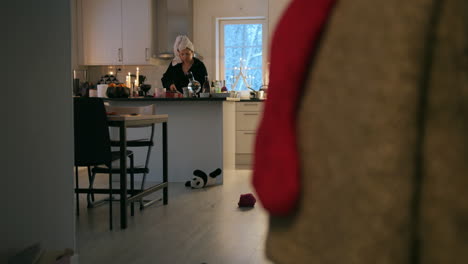 woman prepare breakfast for family early christmas morning, kitchen, wide shot