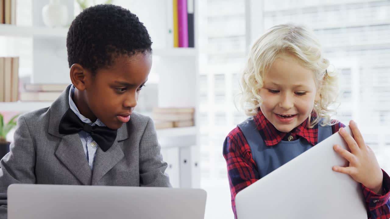 Kids as business executives discussing over laptop 4k