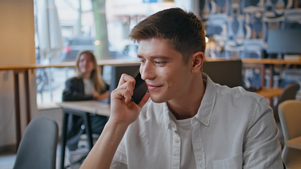 Closeup businessman talking mobile phone at workplace. Happy smiling man calling