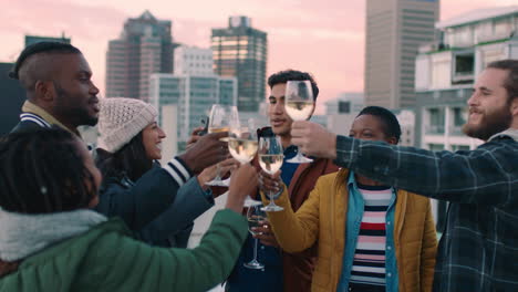 cheerful group of friends enjoying rooftop party celebration drinking alcohol making toast having fun social gathering celebrating weekend of friendship at sunset