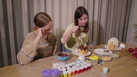 sisters decorating easter bread and eggs