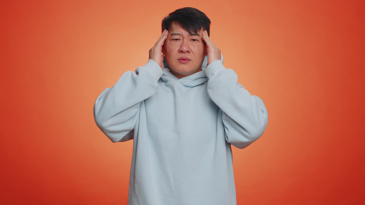 Man rubbing temples to cure headache problem suffering from tension and migaine stress pain