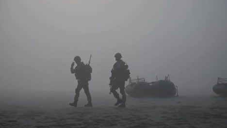 military tactical team navigating misty beach landscape after disembarking from inflatable raft, moving with strategic precision amid dramatic gray atmospheric conditions