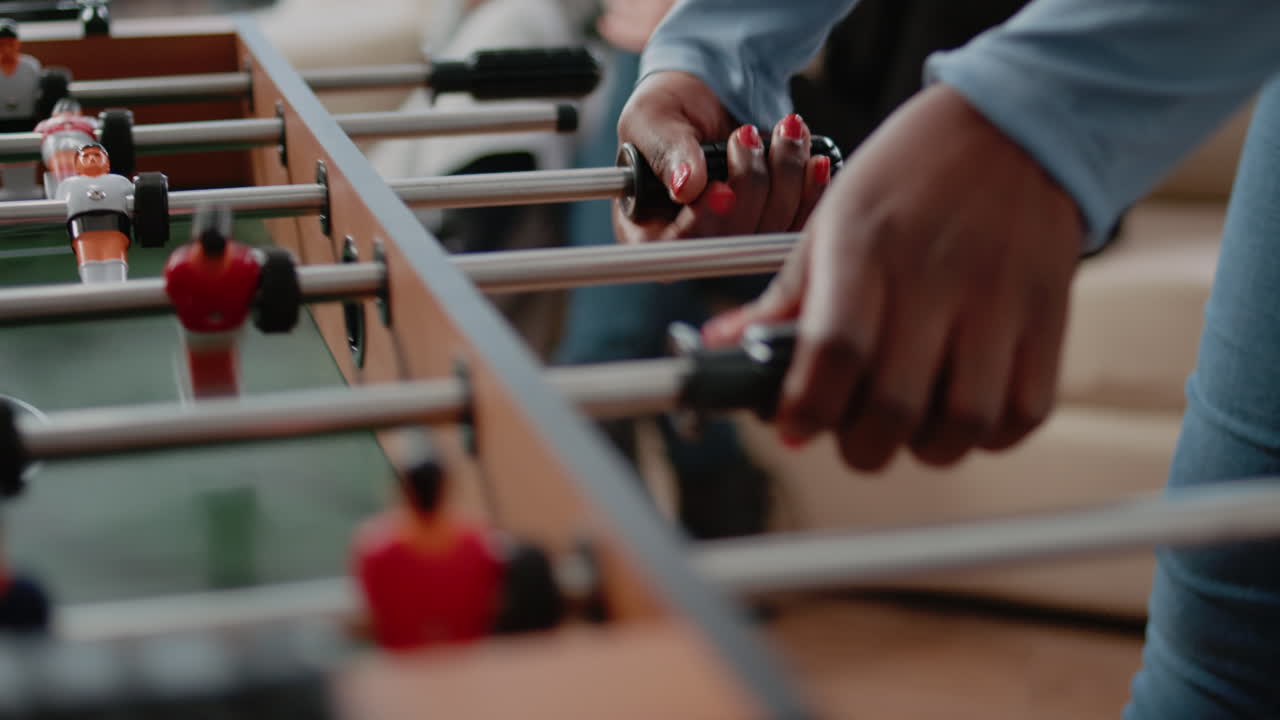 Close up of woman using foosball game table to do fun activity