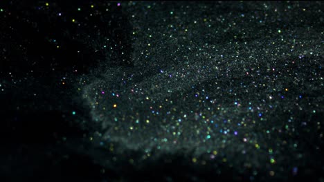 blue and yellow crystals sparkle on black background. fluid art.