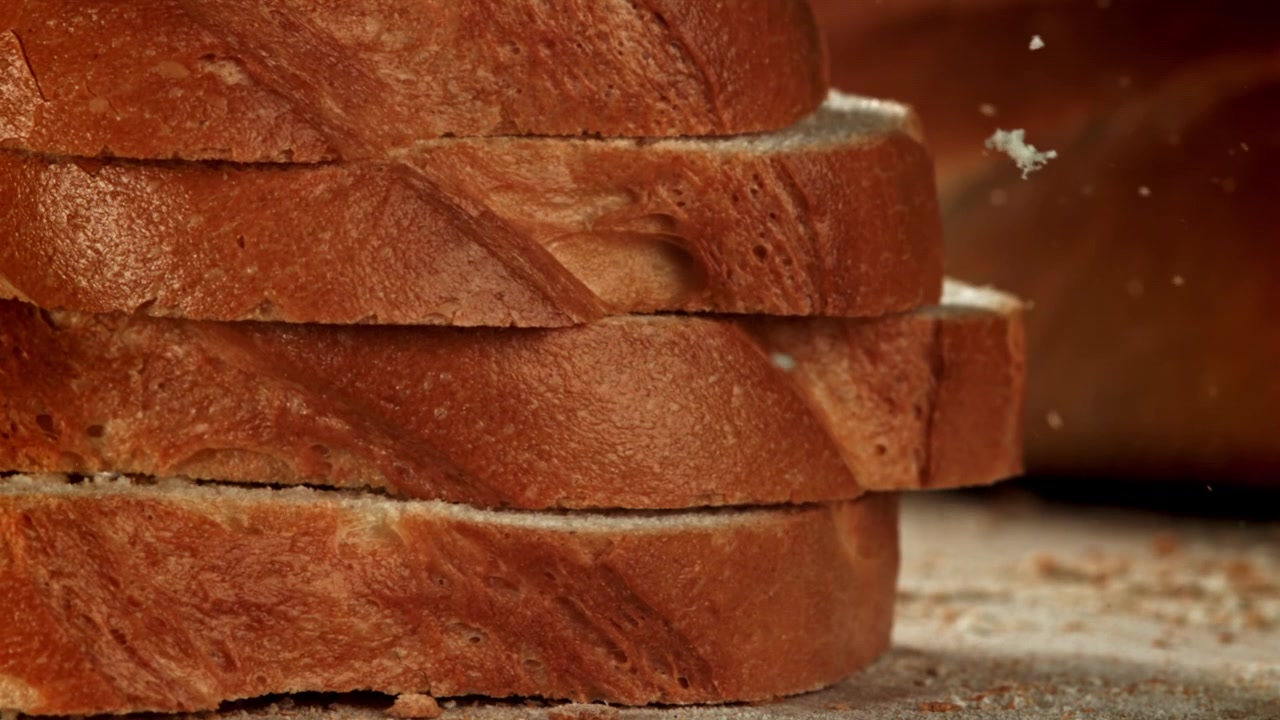 Fresh Bread Slices Falling and Stacking in Slow Motion