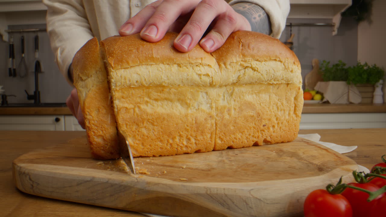 Cutting a loaf of bread in the kitchen