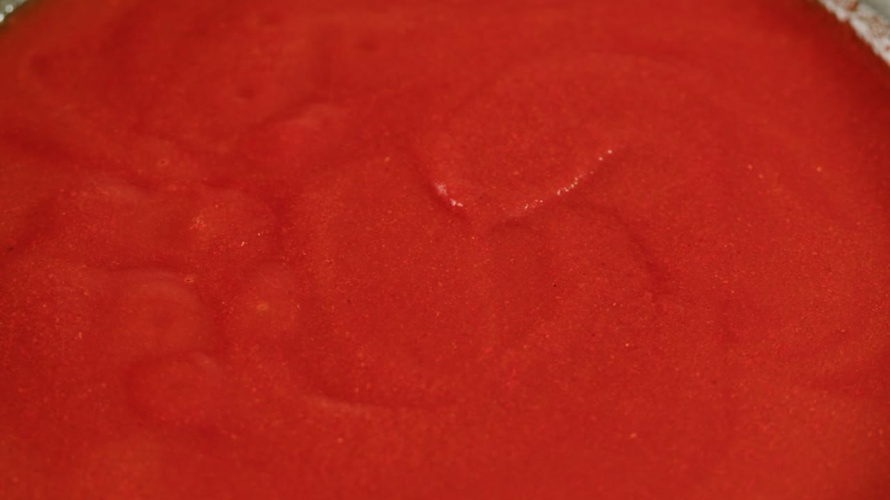 Boiling tomato sauce on a frying pan close-up. Cooking tomato sauce or soup. Traditional Italian Mexican Asian dish. High quality studio shot for cafe, restaurant close up. Marinara sauce for Italian pasta