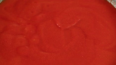 boiling tomato sauce on a frying pan close-up. cooking tomato sauce or soup. traditional italian mexican asian dish. high quality studio shot for cafe, restaurant close up. marinara sauce for italian pasta