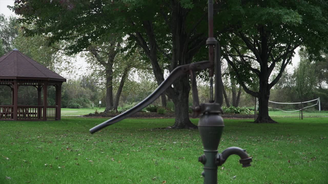 Old metal water pump on an overcast evening before dusk at Seims Park in Union, IL