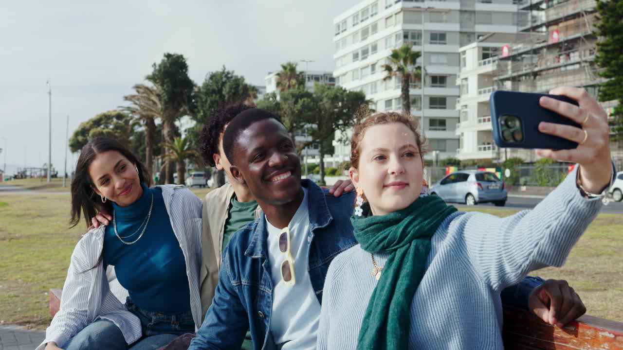 Group of friends taking a selfie in an urban beach setting