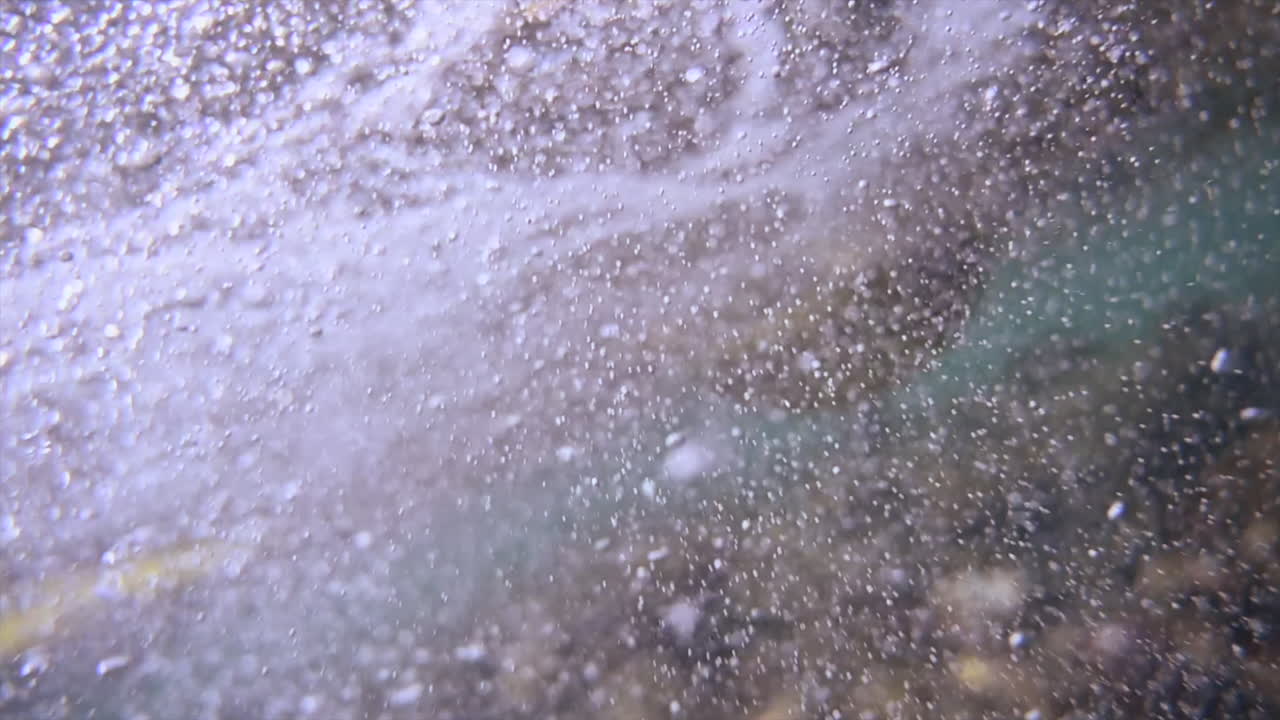 Underwater view of the waves and the bubbles of the red sea