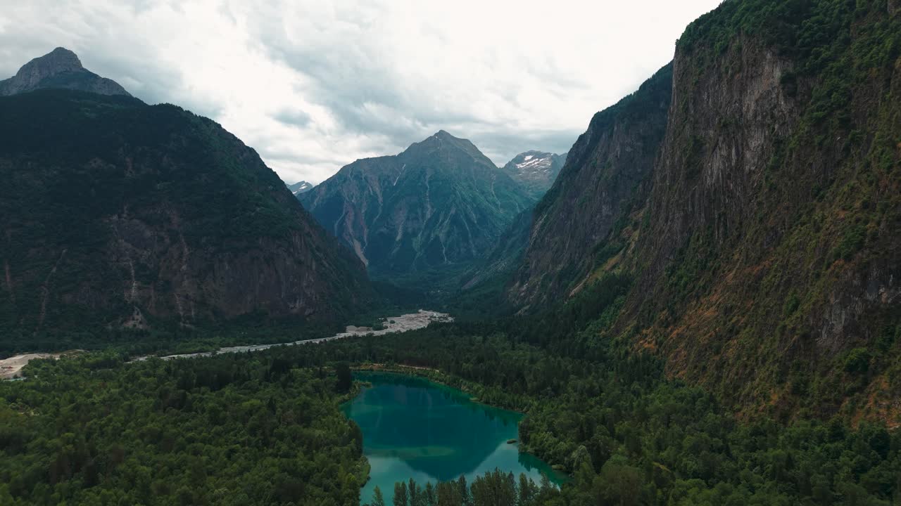 aerial shot over Lake of Buclet near le Bourg d'Oisans in Isere departement, Alps mountain range in the background, Auvergne Rhone Alpes region, France