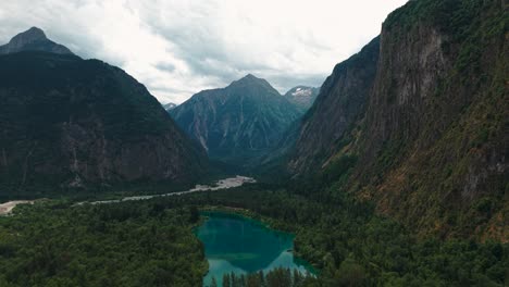 aerial shot over lake of buclet near le bourg d'oisans in isere departement, alps mountain range in the background, auvergne rhone alpes region, france