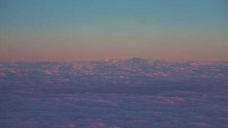 beautiful evening clouds, seen from as window in an airplane are moving in slow motion