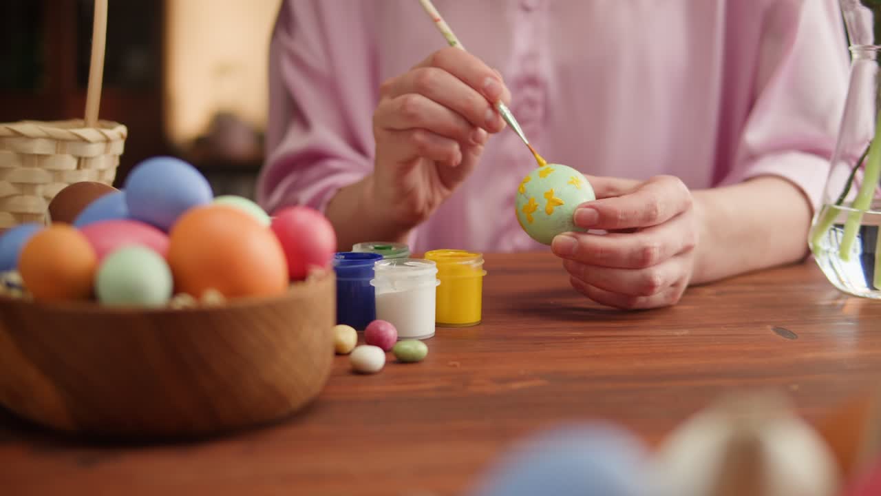 Happy Easter holiday. Coloring eggs close-up. Woman preparing for Easter, painting and decorating eggs. Christian celebration, family traditions.