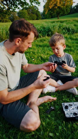 father and son assembling a toy outdoors
