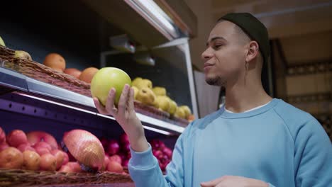 man choosing the right product in a supermarket, take citrus