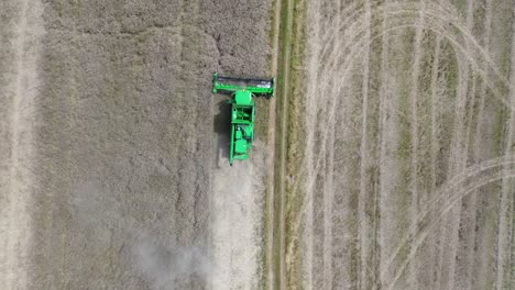 A-view-of-efficient-combined-harvesting-in-action-when-the-camera-from-the-drone-captures-the-harvester-from-above-and-zooms-away-at-the-same-time