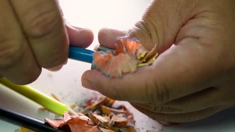 Footage-of-hands-slowly-sharpening-a-pencil-and-some-coloured-pencils-with-a-Wedge-Pencil-Sharpener