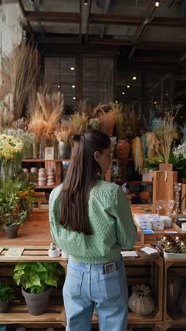 woman browsing a floral shop